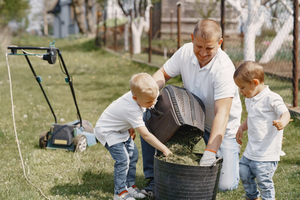 man helping children with lawn care