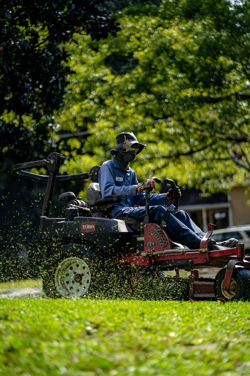 person mowing lawn