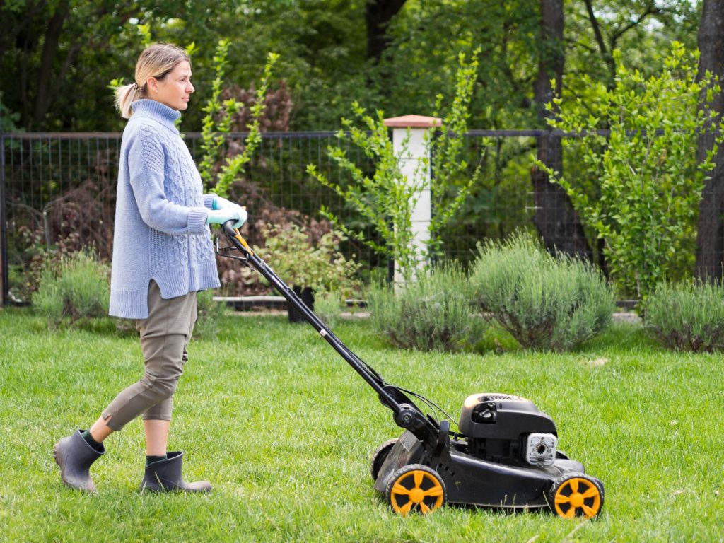 woman mowing the yard