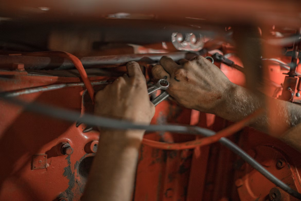 person repairing mower