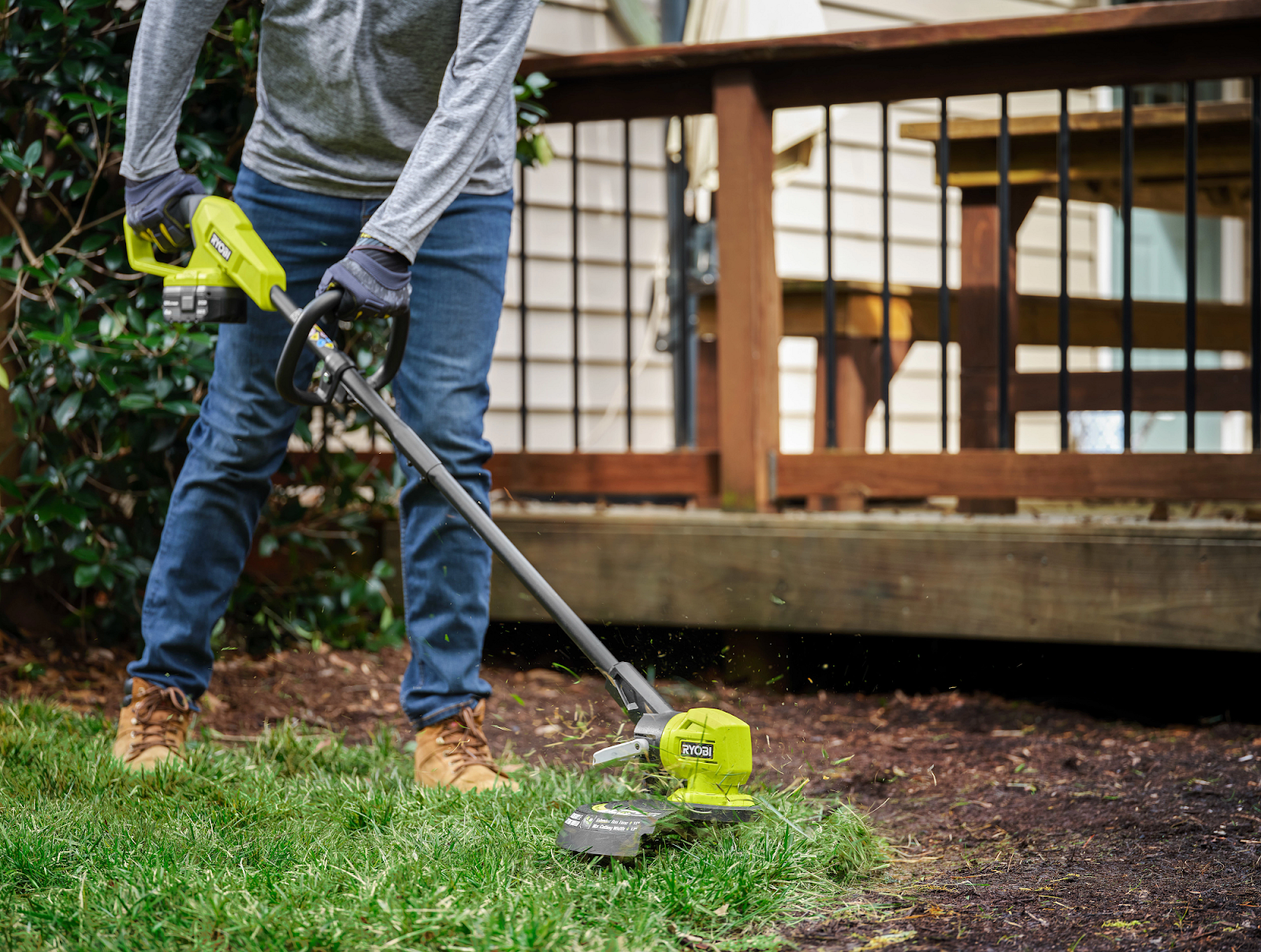 person trimming grass