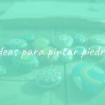 Colorful painted stones with artistic designs, arranged on a wooden table, natural light, creative and relaxing vibe.