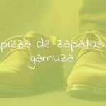 A pair of stylish suede shoes being gently cleaned with a soft brush, warm lighting, realistic.